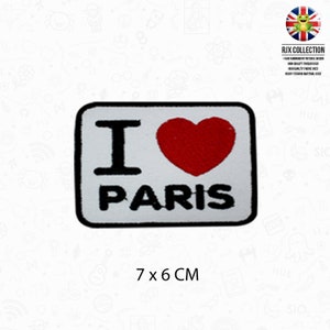 Puede incluir: Parche blanco bordado para planchar con texto negro que dice "I love Paris" y un corazón rojo. El parche mide 7 por 6 centímetros.