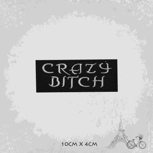 May include: Black embroidered patch with white lettering that reads "CRAZY BITCH". The patch is 10 cm by 4 cm.