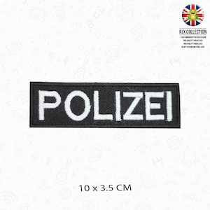 May include: Black and white embroidered patch with the word "POLIZEI" in white lettering on a black background. The patch is 10 cm by 3.5 cm.