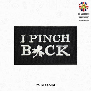 May include: Black embroidered iron-on patch with white text that reads "I Pinch Back" and a white four-leaf clover. The patch measures 7.5 cm by 4.5 cm.