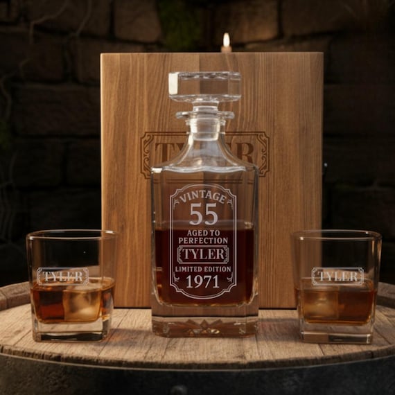 A fully engraved whiskey decanter set tucked into a wooden gift box — the 'Aged to Perfection' personalization for a 55th birthday is a genuinely clever, presentation-ready gift that feels considered rather than grabbed off a shelf.