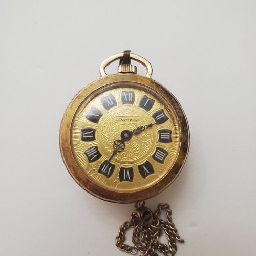 Lucerne watch with tassel - image depicting a woman with her child that has wings and shops a tail