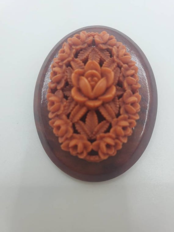 Carved Coral celluloid on wooden fram oval brooch 