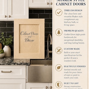 May include: A light-colored wooden Shaker style cabinet door with the text Cabinet Doors and Décor printed on the front. The door is displayed in a kitchen setting with white cabinets, a black tiled backsplash, and a stainless steel sink.