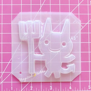 May include: Clear plastic mold for making resin crafts. The mold features a cartoon devil holding a pitchfork. The mold is approximately 2.5 inches tall and 2 inches wide.