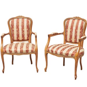 Può includere: Due sedie in stile antico con cornici in legno ornate e rivestimento a strisce rosse e bianche.