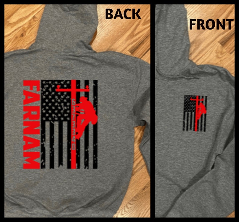 May include: Gray hooded sweatshirt with a red, white, and blue American flag design. The flag has a silhouette of a lineman climbing a utility pole. The text "FARNAM" is printed vertically on the left side of the flag.