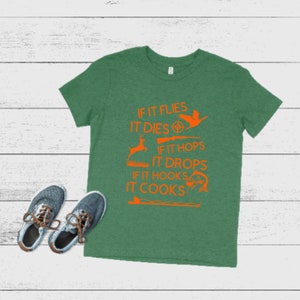 May include: Green t-shirt with an orange graphic that says "If it flies it dies, if it hops it drops, if it hooks it cooks".