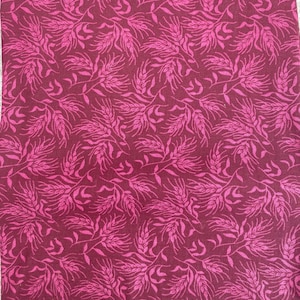 Pode incluir: Um tecido bordô com um padrão repetido de espigas de trigo cor-de-rosa. O tecido tem uma textura sutil.