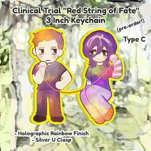 May include: A 3 inch keychain featuring two cartoon figures connected by a red string. The figures are a man with orange hair and a woman with purple hair. The keychain has a holographic rainbow finish and a silver U clasp. The text "Clinical Trial "Red String of Fate" (pre-order!) Type C" is visible in the image.