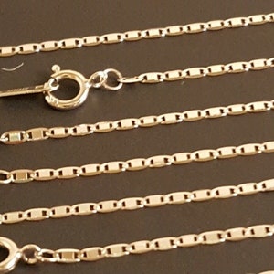 May include: Four silver chains with lobster claw clasps. The chains are made of small, rectangular links.