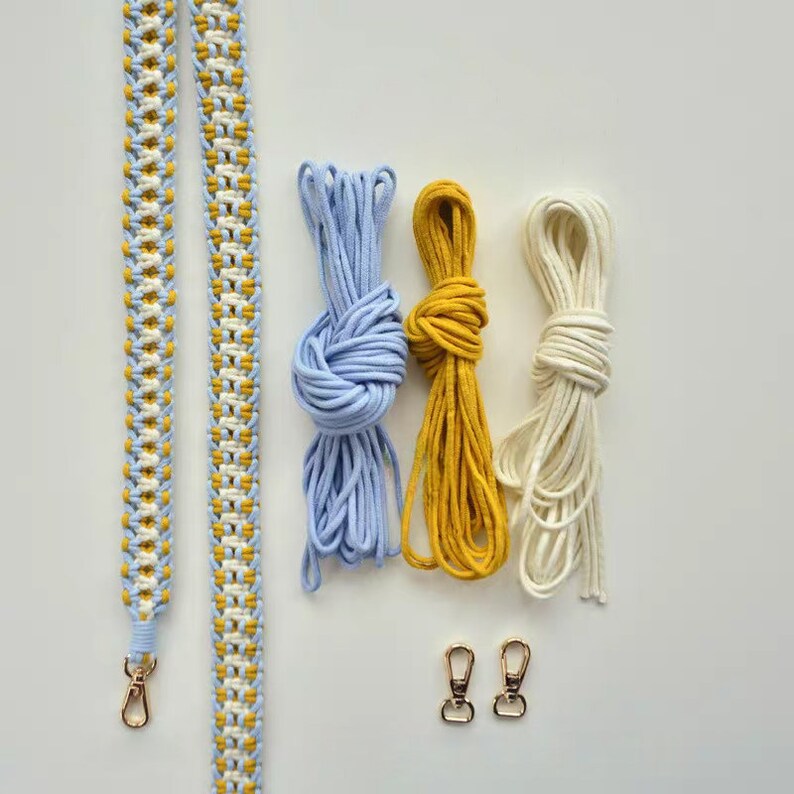 May include: A set of three spools of cord in blue, yellow, and white, along with a finished braided strap and two gold metal clasps.