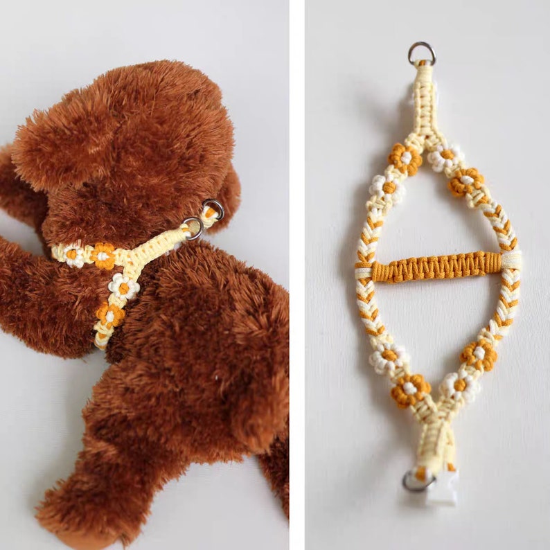 May include: A yellow and white macrame dog harness with daisy-shaped knots. The harness is shown on a brown stuffed animal and hanging on a white background.