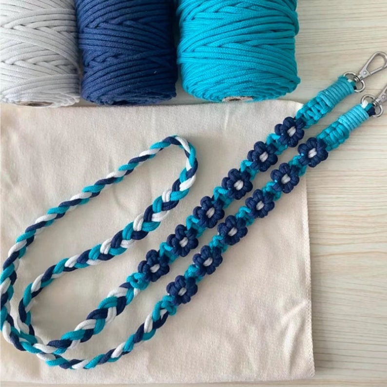 May include: A handmade macrame cord necklace with blue and white braided cord and flower accents.