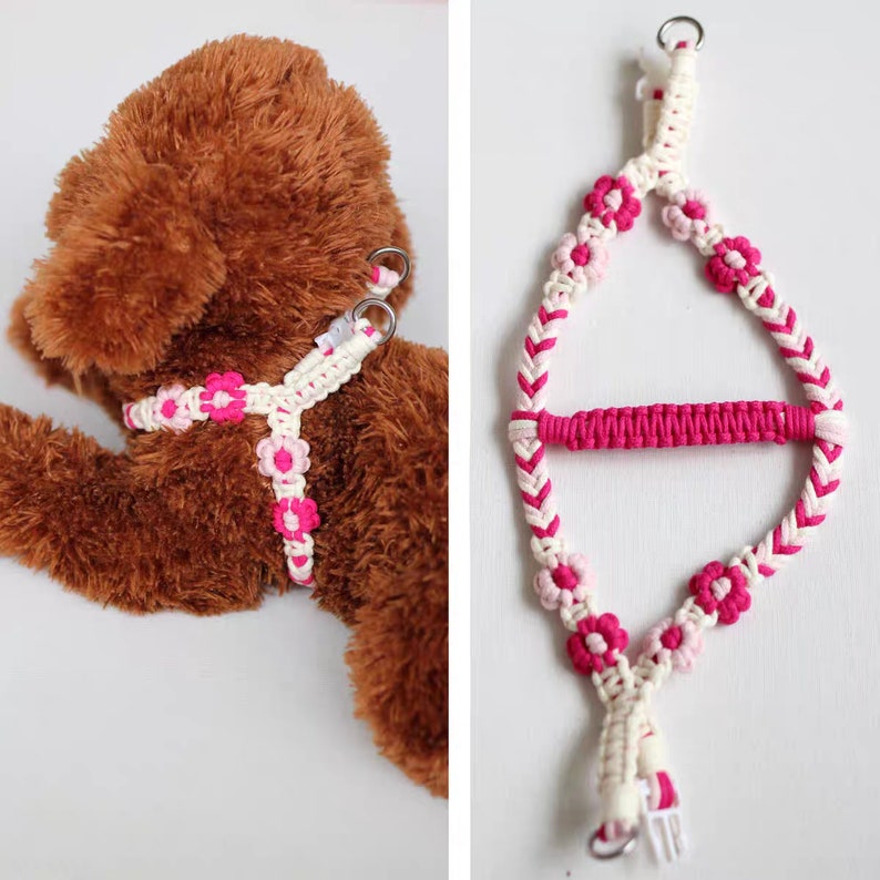 May include: A pink and white dog harness with flower accents. The harness is made of braided rope and has a metal ring for attaching a leash.