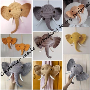 Puede incluir: Una colecci&oacute;n de cabezas de elefante de crochet para colgar en la pared, en varios colores, incluyendo gris, beige y amarillo. Los elefantes tienen colmillos de hilo blanco y est&aacute;n hechos con un punto texturizado.