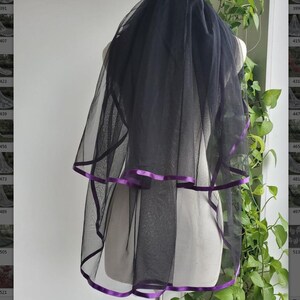 May include: Black bridal veil with a double layer of purple satin ribbon trim.