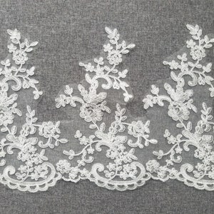May include: White lace trim with a floral design. The lace is about 2 inches wide.