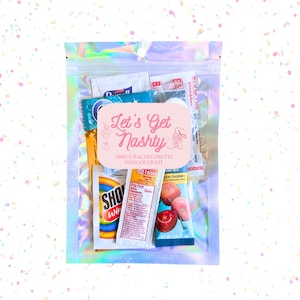 May include: A clear, iridescent zip-lock bag filled with various items. A pink label reads "Let's Get Nashy" with "Abby's Bachelorette Hangover Kit" below. Contents include packets of medicine, wipes, and drink mix.