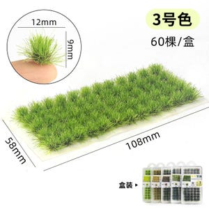 May include: A rectangular patch of artificial grass, 108mm long and 58mm wide, with a sample piece held by a finger. The grass is a vibrant green color. The text in the image reads "3 color" and "60 pieces/box".