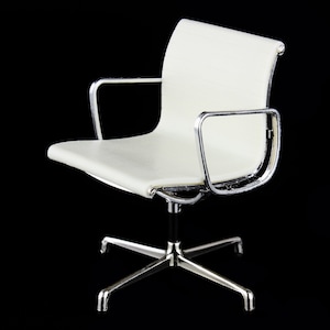 May include: A white office chair with a chrome frame and a swivel base. The chair has a padded seat and back.