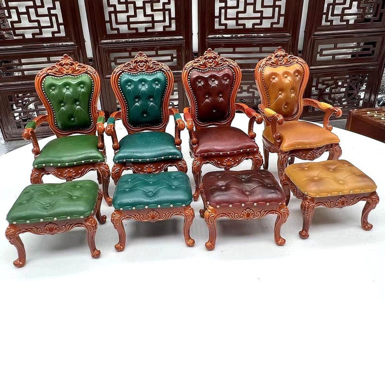 May include: Set of five miniature chairs and ottomans with ornate wooden frames and upholstered seats in green, brown, and tan.