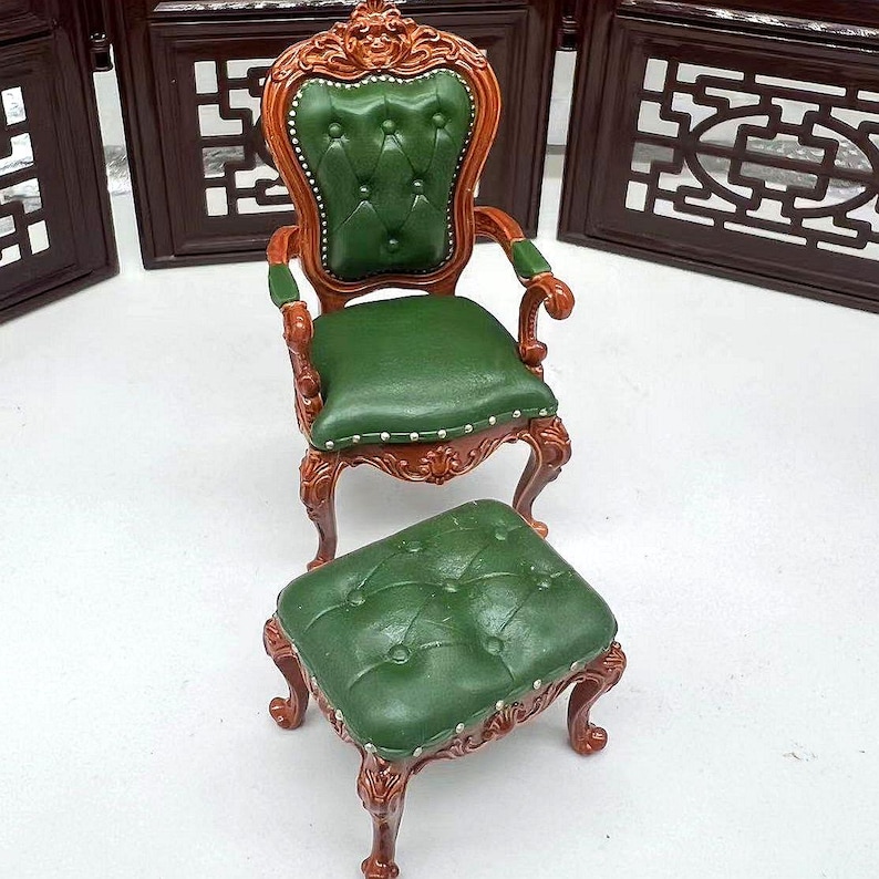 May include: A green upholstered armchair with a matching footstool. Both pieces have ornate wooden frames and tufted upholstery.
