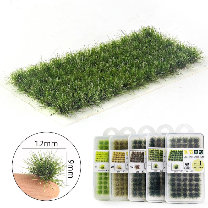 May include: A rectangular patch of green model grass, packaged in clear plastic, with a close-up showing a 0.47-inch tall tuft. Several small containers of seasonal grass tufts are also visible, each with a different shade of green.