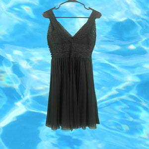 May include: A black sleeveless dress with a lace bodice and a flowing skirt.