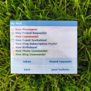 May include: A rectangular card with the words "My Mail" at the top. The card lists various notifications such as "New Messages!" and "New Friend Requests!" in a blue and white design. The card is set against a backdrop of green grass.