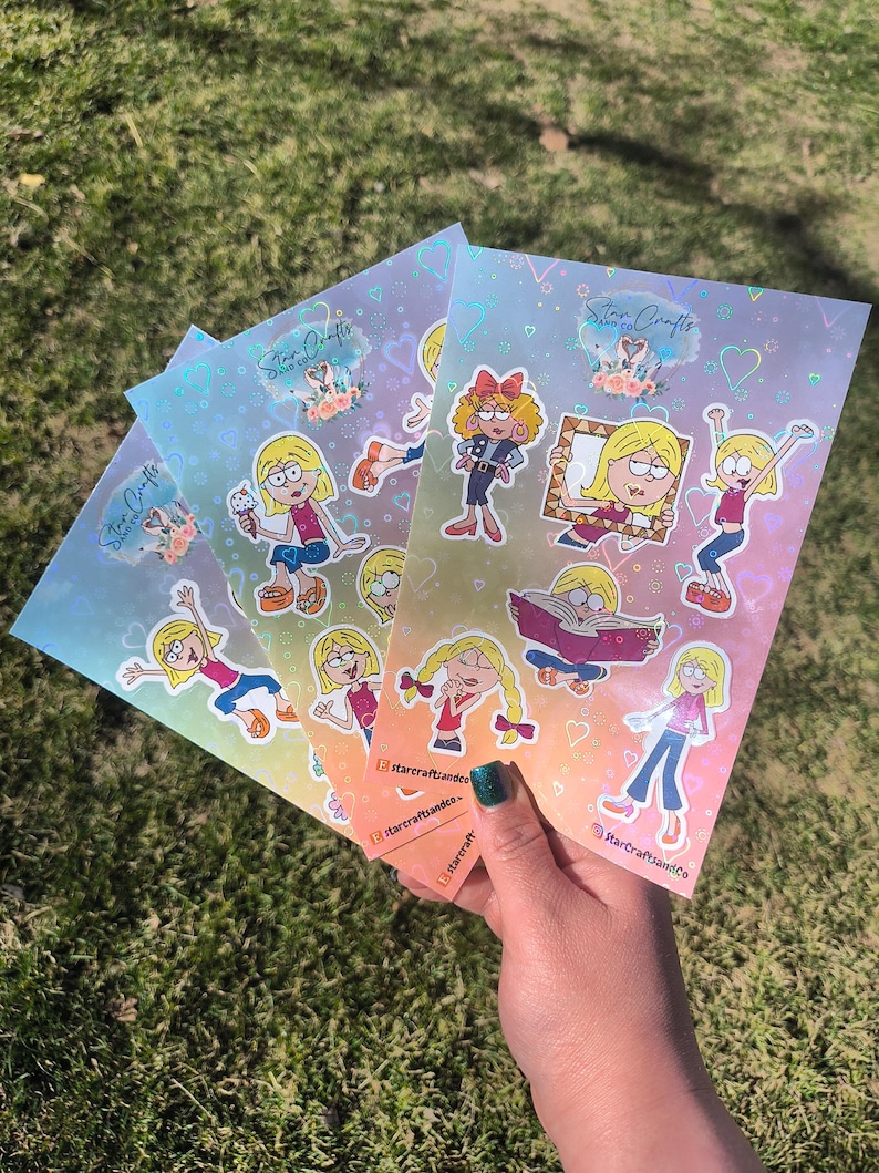 May include: Four sheets of holographic sticker paper with colorful cartoon illustrations of girls with pigtails, hearts, and the text "Star Crafts and Co."