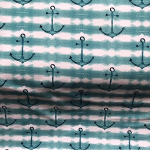 May include: A teal and white fabric with a repeating pattern of anchors. The anchors are a dark teal color and are set against a white background with teal stripes.