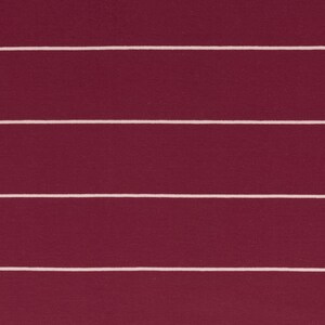 May include: A close-up of a burgundy fabric with white horizontal stripes. The fabric has a textured surface.