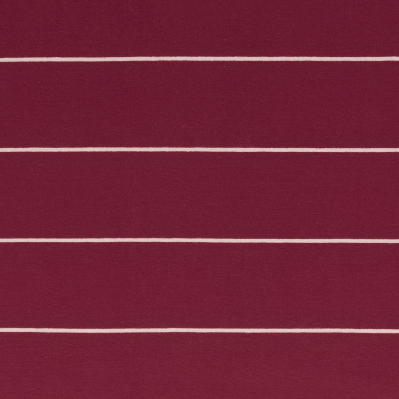 May include: A close-up of a burgundy fabric with white horizontal stripes. The fabric has a textured surface.