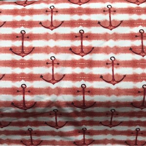 May include: Red and white striped fabric with a repeating pattern of anchors. The anchors are a dark red color and are painted in a watercolor style.