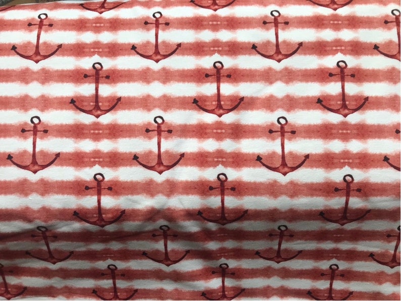 May include: Red and white striped fabric with a repeating pattern of anchors. The anchors are a dark red color and are painted in a watercolor style.