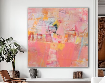 May include: Abstract painting in shades of pink, yellow, and white with geometric shapes and lines. The painting is hanging on a white wall in a living room setting with furniture.