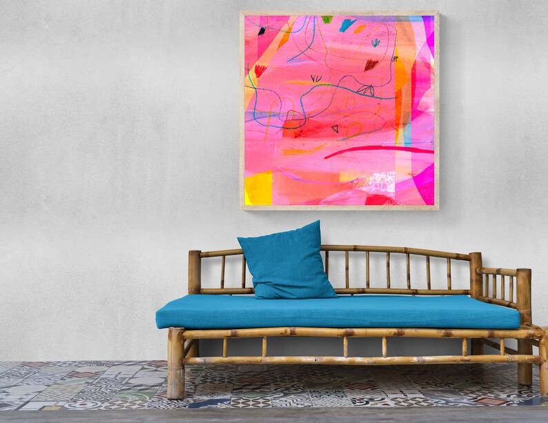 May include: A blue cushion sits on a bamboo daybed with a colorful abstract painting hanging on the wall behind it.