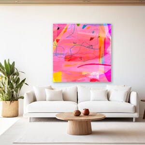 May include: Abstract painting with pink, red, orange, yellow, blue, and green colors. The painting has a white background and is framed in a white frame.