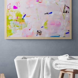 Peut inclure: Une peinture abstraite encadr&eacute;e avec un fond rose clair et des coups de pinceau color&eacute;s dans des tons de bleu, vert, jaune et rose. La peinture est accroch&eacute;e &agrave; un mur bleu clair au-dessus d'une baignoire blanche.