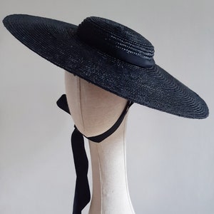 Wide brimmed black straw boater hat