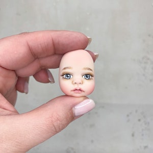 Doll faces for making plush doll. Sculptural parts of the doll’s body