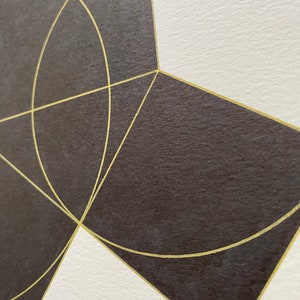 May include: A geometric design with black and gold shapes. The design features a series of overlapping circles and squares with gold lines.