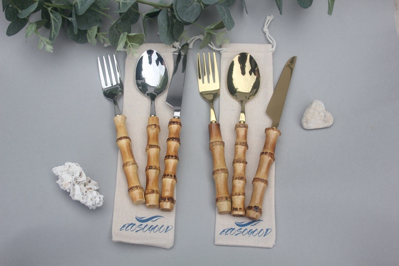 Cutlery set with steel ends and a handle made from real bamboo pieces with nodes. Set consists of 3 pieces and the ends are either gold or silver. They come with an Ecosogood branded drawstring pouch. Photographed with leaves & white stones