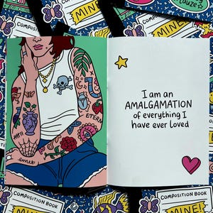May include: Open composition book with a colorful illustration. The left page features a person with tattoos, wearing a white tank top and blue shorts. The right page has the text "I am an AMALGAMATION of everything I have ever loved."