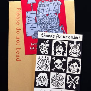 May include: A brown package with a red card showing a drawing of a lamp, clothes, and boxes labelled "Pokemon", "Art Stuff", and "Kitchen Shit". A black and white card with illustrations and the text "thanks for ur order!" and "love from Lauze".