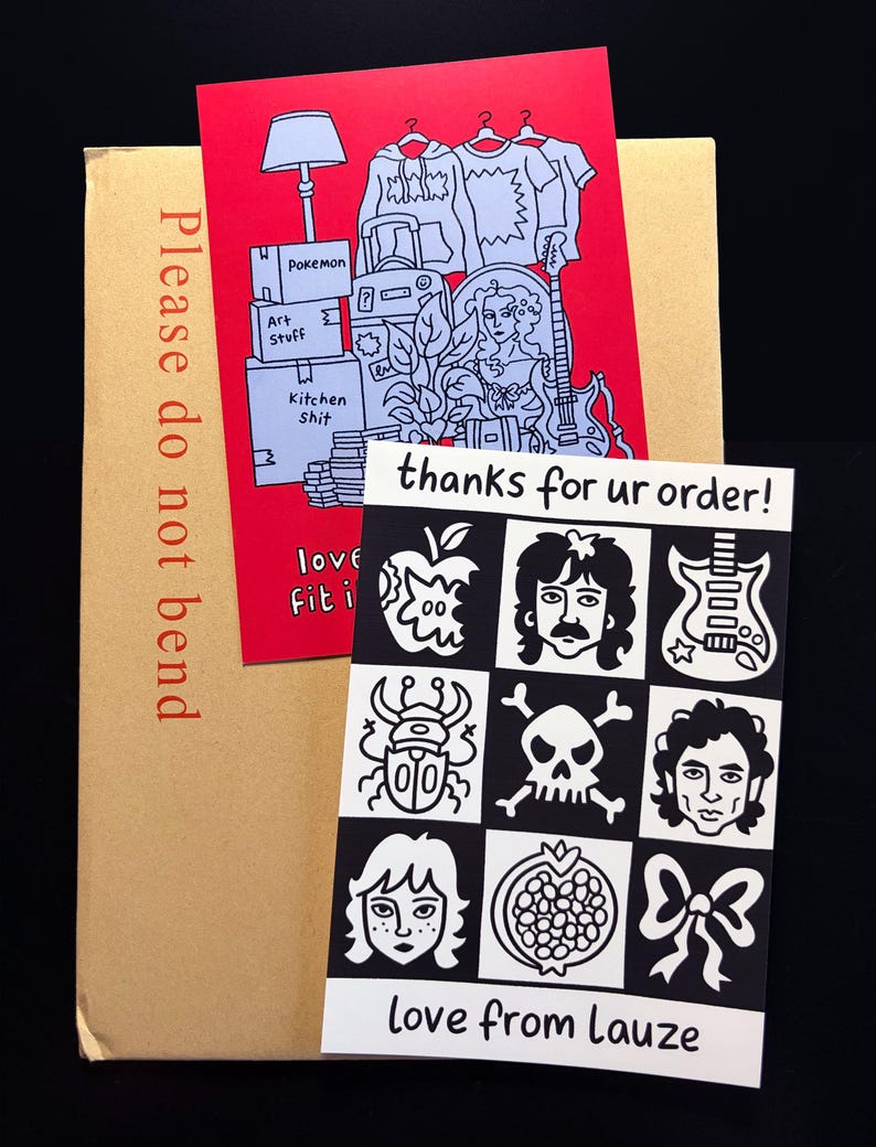 May include: A brown package with a red card showing a drawing of a lamp, clothes, and boxes labelled "Pokemon", "Art Stuff", and "Kitchen Shit". A black and white card with illustrations and the text "thanks for ur order!" and "love from Lauze".