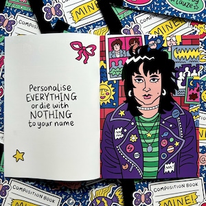 May include: An open notebook with the text "Personalise EVERYTHING or die with NOTHING to your name" and a cartoon illustration of a person wearing a purple jacket. The background is a blue pattern with various stickers.
