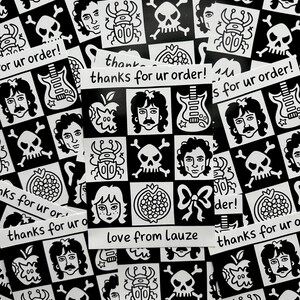May include: A collection of black and white stickers with various illustrations, including faces, skulls, guitars, and apples. Some stickers have the text "thanks for ur order!" and "love from Lauze".