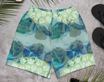 Könnte beinhalten: Grüne, blaue und weiße gemusterte Herren-Badehose mit tropischem Blätterdesign.